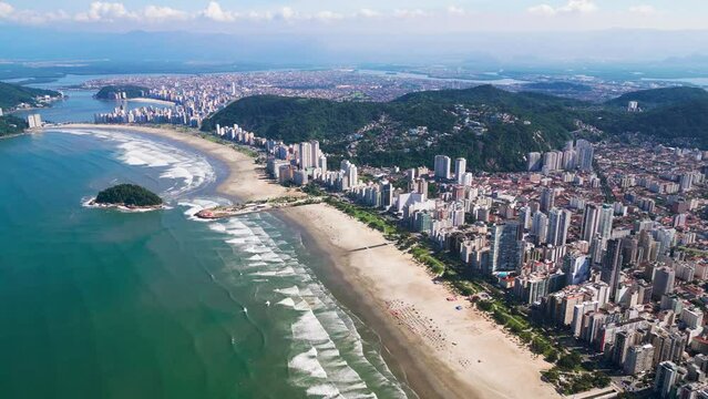 Amazing aerial view of the city of Santos. Aerial view of Santos Bay overlooking Urubuque&ccedil;aba Island and a Tomie Ohtake sculpture. City of S&atilde;o Vicente in the background.