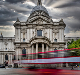 Long exposure red bus in capital against church