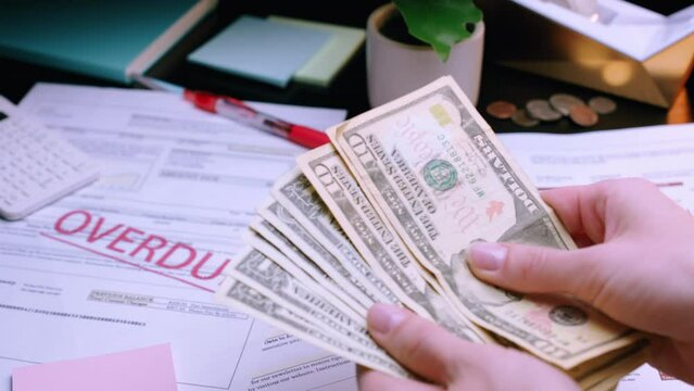 Caucasian Woman Hands Counting Money for Overdue Utility Bills. Shot with ARRI Alexa in ArriRaw at 120 fps, exported 23.98 fps QuickTime Apple ProRes 422 HQ.