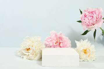 Minimal floral composition.Abstract background with empty podium and peonies flowers,empty showcase for display or presentation of cosmetic products,postcard with place for text