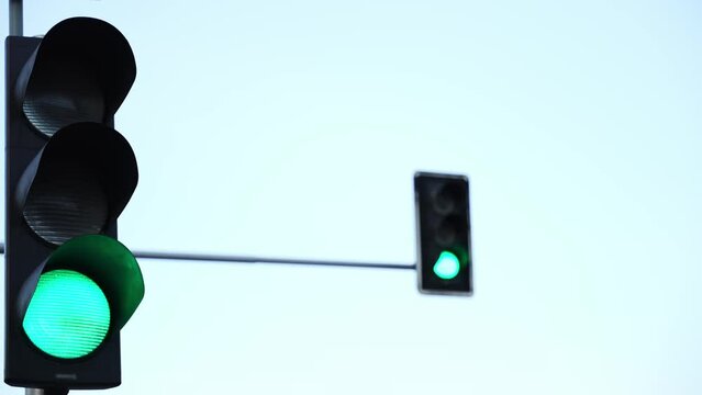Traffic light change color on  city crossroad. Green red lights warning drivers on street.