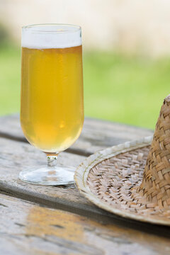 glass of beer and hat on the teable