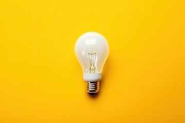 white light bulb on a yellow background