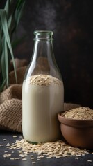 Obraz na płótnie Canvas Vegan lactose free oat milk in glass bottle with oat flakes cereal and grass. 