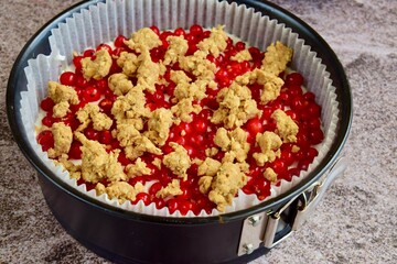 Making of red currant cheesecake crumble dessert