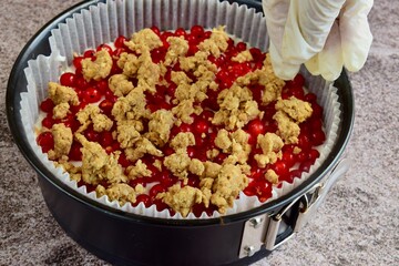 Making of red currant cheesecake crumble dessert