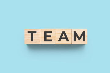 Team wooden cubes on blue background