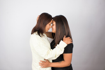 photograph of a female couple on a light photographic studio background.