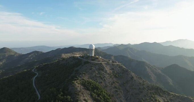 Aerial view of the observatory building in the mountains in a beautiful landscape. Science by astronomers and the study of stars by scientists using a telescope. High quality 4k footage