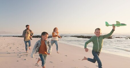 Happy, holiday and family running, seaside vacation or energy with happiness, ocean or loving together. Parents, mother or father with children, adventure or relax with stress relief or beach getaway