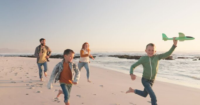 Happy, holiday and family running, seaside vacation or energy with happiness, ocean or loving together. Parents, mother or father with children, adventure or relax with stress relief or beach getaway