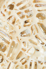 iced coffee and ice background,Close-up of Cold latte drink with ice cubes,