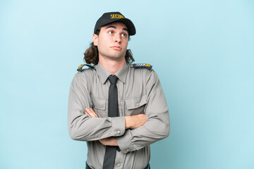 Young safeguard man isolated on blue background making doubts gesture while lifting the shoulders