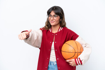 Young caucasian woman playing basketball isolated on white background giving a thumbs up gesture