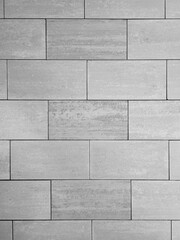 Gray textured ceramic tiles is lined offset.