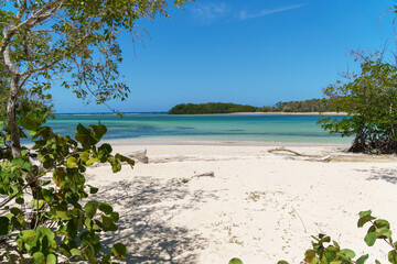 Empty strand of beach in estero hondo dominican republic, with fine sand and a distant island.