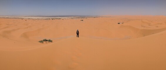 Hiking up the Great Dune of Merzouga in the Erg Chebbi desert, Moroccan Sahara