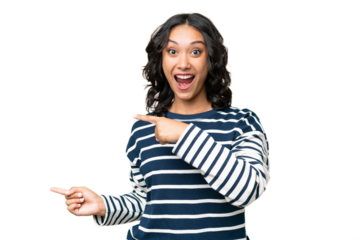 Young Argentinian woman over isolated background surprised and pointing side