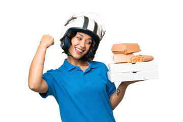 Young Argentinian deliver fast food over isolated background celebrating a victory