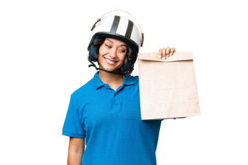 Young Argentinian woman taking a bag of takeaway food over isolated background with happy expression