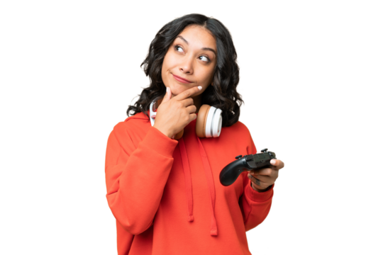 Young Argentinian woman playing with a video game controller over isolated background and looking up