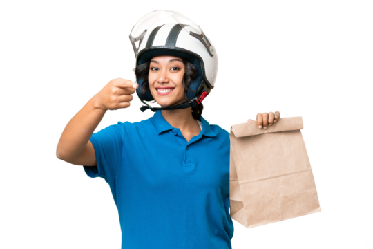 Young Argentinian woman taking a bag of takeaway food over isolated background points finger at you with a confident expression