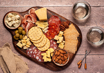 Food photography of antipasto, cheese, cheddar, cracker, parmesan, salami, prosciutto, feta, almond, pecan, wine,  dip, mediterranean food