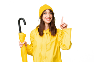 Young caucasian woman with rainproof coat and umbrella over isolated chroma key background pointing up a great idea