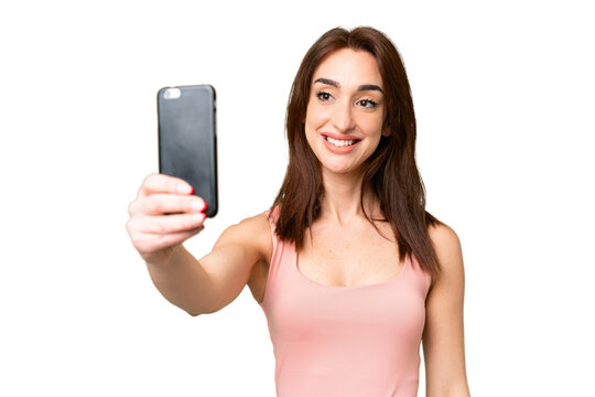 Young caucasian woman over isolated chroma key background making a selfie with mobile phone