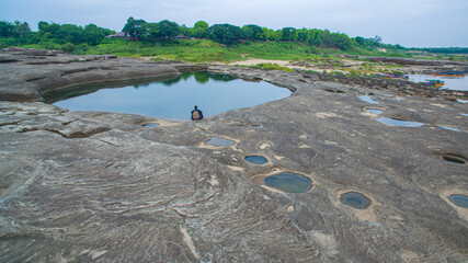 aerial photography around grand canyon in Mekong river. .3000 bok mean 3000 holes,holes eroded into the rock along Mekong river. .color of water inside the holes after low tide is emerald green