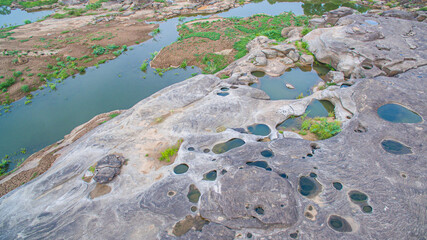 aerial photography around grand canyon in Mekong river. .3000 bok mean 3000 holes,holes eroded into the rock along Mekong river. .color of water inside the holes after low tide is emerald green