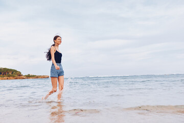 Fototapeta na wymiar smile woman young sea happiness sunset summer running lifestyle beach travel