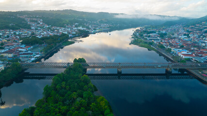 Metal bridge with sky reflection in river water with the light of sunrise. Paragua&ccedil;u River in Cachoeira and S&atilde;o F&eacute;lix Bahia Brazil