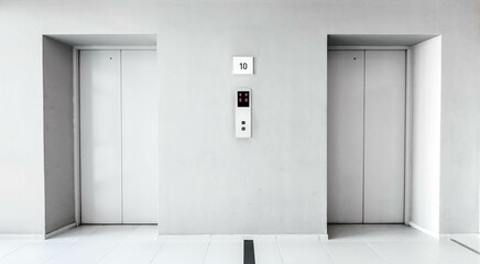 Elevators door closed in the hallway condominium. Light grey interior building with metal lifts,...