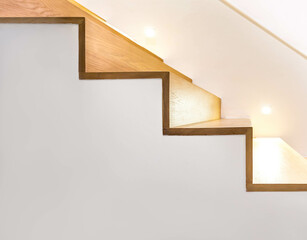 Side view modern loft, wooden staircase with lights bulb for illumination as safety protection. Minimal architecture interior design of the contemporary house. Bright space and warm construction style