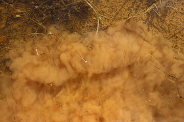 Clay suspension in the water raised from the bottom of the reservoir
