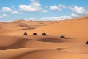 Fototapeta na wymiar Motor quads driving off-road in the Erg Chebbi desert near Merzouga