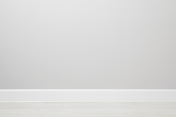 White plinth on laminated floor near wall indoors