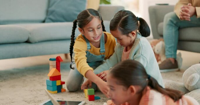 Family, happy and children play with toys for bonding, quality time or child development at home. Parents, siblings and kids learning with tablet, building blocks and relax in living room on playdate