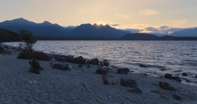 Aerial: wind over Lake at sunset, Manapouri, New Zealand