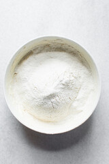 All purpose flour in a ceramic bowl, baking flour in a bowl