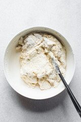 Lemon cake batter in a mixing bowl, process of making cakes and muffins, folded batter