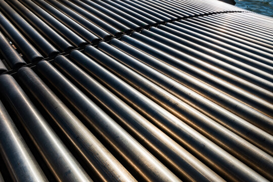 Steel conveyor belt rollers shine in the sun