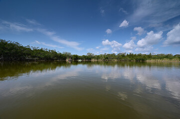 Distant kayaker and fisherman on Nine Mile Pond in Everglades National Park, Florida on calm sunny April afternoon.