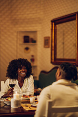 African american couple having romantic date and drinking wine at home