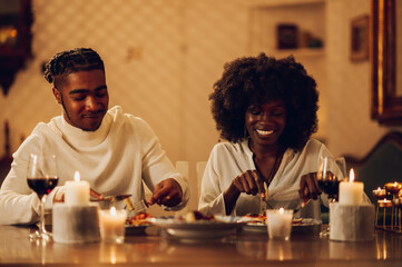 African american couple having romantic dinner date at home