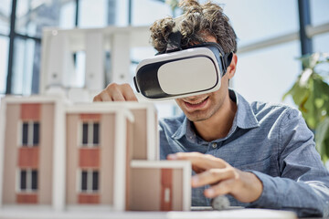 man sits in the office of a realtor and looks at the layout of the apartment in virtual reality...