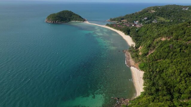 Ko Phangan, Thailand: Dramatic aerial drone video of the Haad Mae beach and island in the Koh Pha Ngan island in the gulf of Thailand in Southeast Asia. Shot with a tilt up motion. 