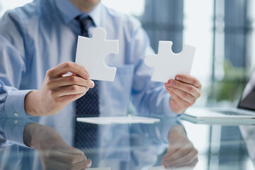 optimistic businessman holding a puzzle piece, solving problems,
