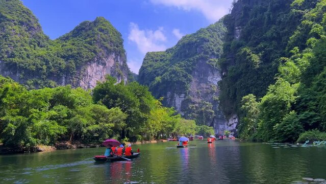 Trang An River Ninh Binh and Bai Dinh Mountain ranges in Vietnam only 3 hours drive from Hanoi. Beautiful winding river and large rising mountains. boats going through the caves in the river